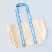 Load image into Gallery viewer, Beige canvas tote bag with blue handles featuring Cinderella quotes on a light blue background
