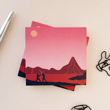 Load image into Gallery viewer, Stack of Post Its featuring Mustafar on a colored surface with a pen and paper clips.