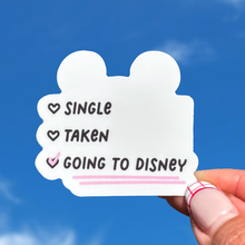 Load image into Gallery viewer, Sticker with text 'Single', 'Taken', 'Going to Disney' held against a blue sky.