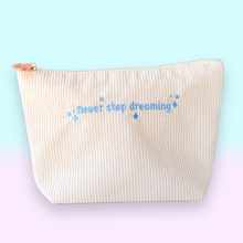 Load image into Gallery viewer, Beige pouch with 'never stop dreaming' text on a light blue background