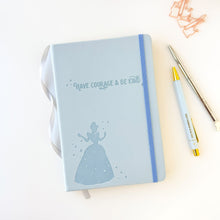 Load image into Gallery viewer, Light blue notebook with Cinderella silhouette and 'Have courage & be kind' text on a white background