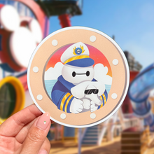 Load image into Gallery viewer, Porthole cruise ship magnet with captain character holding an elephant towel animal