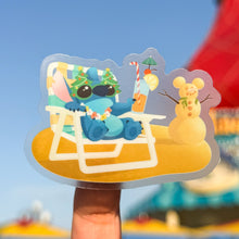 Load image into Gallery viewer, Sticker of a cartoon character relaxing on a beach chair with a blurred background
