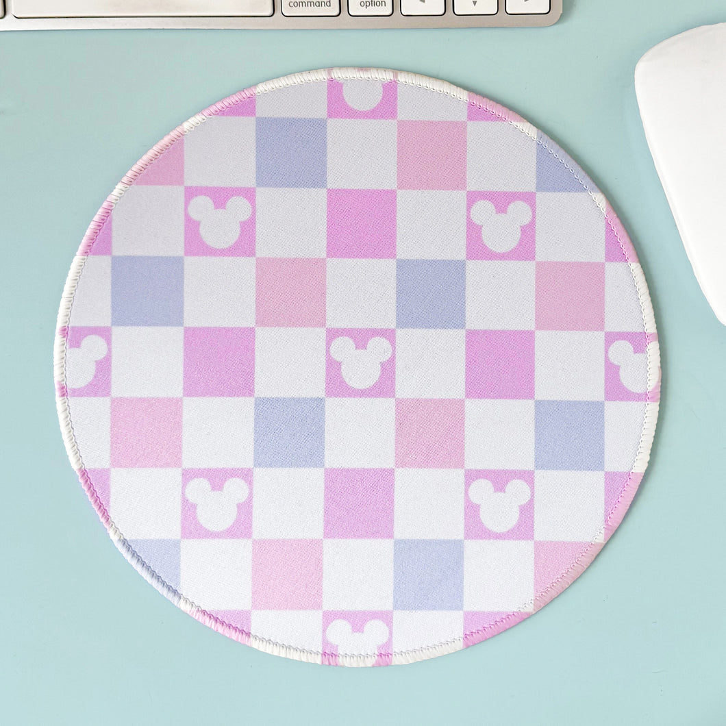 Round mouse pad with checkered pattern and Mouse icons on a light blue surface.