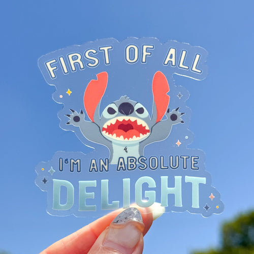 Sticker with cartoon character holding text 'First of all I'm an absolute delight' against a blue sky.