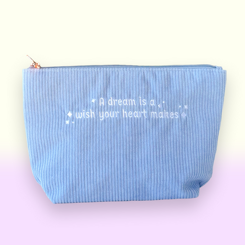 Baby blue corduroy pouch with an embroidered quote and magical sparkles
