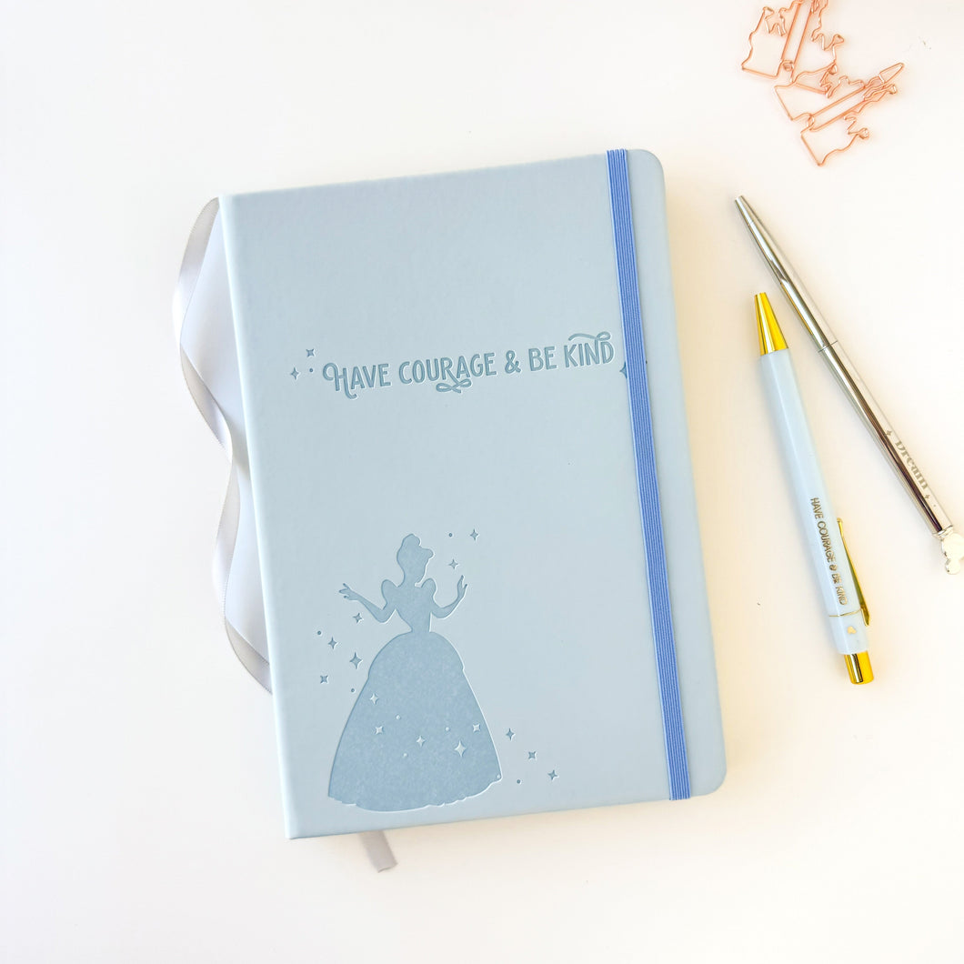 Light blue notebook with Cinderella silhouette and 'Have courage & be kind' text on a white background