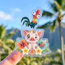 Load image into Gallery viewer, Sticker with cartoon rooster Hei Hei and pig Pua surrounded by flowers held against a tropical background.
