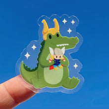 Load image into Gallery viewer, Croc Loki with Thor Plushie Transparent  Sticker
